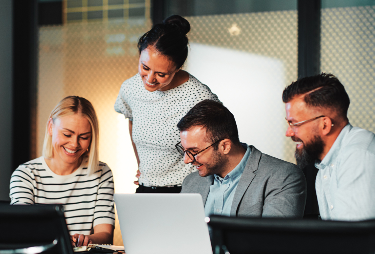 Team arbeitet gemeinsam am Laptop in moderner Arbeitsumgebung für Change Management und Organisationsberatung Weiterbildung – TASys